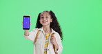 Girl, child and mobile green screen on studio background for news, information or back to school registration. Face of happy kid with education phone app, e learning platform or mockup for sign up