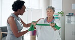 Women, physiotherapist and senior patient for rehabilitation with resistance band for support, progress and healthcare. People, injury and happy in clinic for fitness, exercise and workout for trust