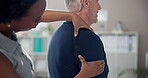 Senior, man and physiotherapist with massage for shoulder pain in clinic with healthcare and injury treatment. Physical therapy, medical expert and elderly patient with arthritis and rehabilitation