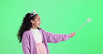 Wand, girl and princess costume on green screen for magic, manifest and spell with wow for deal or prize. Face of excited kid in tiara, crown and cosplay, fairy or fantasy mockup on studio background