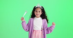 Girl, child and princess with face by green screen with wand, funny and spell by studio background. Kid, magic and royalty with crown, power or playful laugh for fantasy with games by mock up space