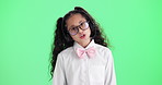 Girl, child and call center in studio with talk, glasses and headphones with voip mic by green screen background. Kid, consultant or agent with games, funny or learning with telemarketing in portrait