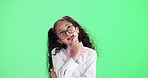 Child, girl and thinking with glasses on green screen for decision, choice or intelligence in education and learning. Young student or kid with idea, solution or guessing in quiz on studio background