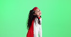 Girl, hero and child in cape by green screen for smile, thinking and funny games by background. Kid, happy and playful with mask, comic and fight crime in fantasy with superpower by mock up space