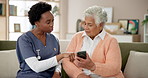 Senior, woman and caregiver consulting with smartphone for explaining, tech assistance and teaching online features. Nurse, old person and internet for health and wellness app for medication reminder