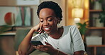 Happy, black woman and relax with smartphone on sofa for home automation control, remote access and integration. Girl, laughing and online with mobile phone for comfort, convenience and efficiency.