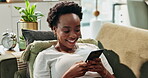 Smile, black woman and relax with smartphone on sofa for home automation control, remote access and integration. Girl, laughing and online with mobile phone for comfort, convenience and efficiency.