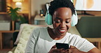 Black woman, smartphone and relax with music on sofa for streaming audio, listening and enjoyment with happiness. Girl, mobile phone and headphones in home with internet, radio and playlist app.