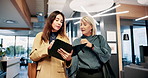 Walking, women and reading of report, tablet and explaining of loan with tax, company and boss. Talking, accountant and CEO with discussion for launch of publishing agency, finance and accounting