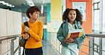 Happy, children and books with walking, together and backpack for extracurricular at academy. Students, talking and smile for education, development and scholarship in learning, friendship and school