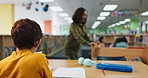 Boy, studying and reading with book in library for education, learning or literature at school. Back view of young male person, teenager or child with librarian for access to information at bookstore
