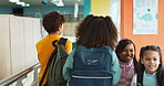 Back, children and friends with walking, hallway and positive in together, campus or academy. Students, kids group and corridor for education, development and scholarship in learning, class or school