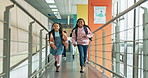 Happy girls, running and school with bags for break, recess or class together in academic building. Group of young students, children or kids with smile or backpack for education or learning journey