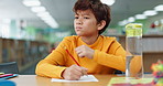 Boy, studying and thinking for math at library in school with notebook for writing notes. Kid, education and homework with stationery for project with numbers for child growth and brain development