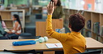 Hand, back and child with question in library for studying, help and academic support at school. Student, learning and boy with gesture at desk for homework feedback, education or assistance of tutor