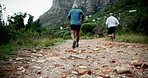 Mature man, friends and running with mountain trail in fitness, exercise or outdoor workout in nature. Back view of senior, male person or runner in trekking, training or hiking on rock path together