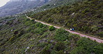 Runner, path and aerial view in mountain with exercise, fitness and marathon training with people in nature. Running, morning workout and outdoor with dirt road, athlete and drone on eco park trail