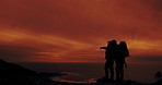 Sunset, people and pointing at horizon on mountain for view, peace and scenic in nature. Silhouette, men and summit in evening for direction, navigation and adventure for fitness and heathy lifestyle