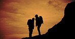 Hiking, silhouette and talking with friends in mountains at sunset together for adventure or exercise. Conversation, fitness and hobby with hiker people outdoor in nature for bonding or challenge