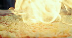 Flame, melting cheese and pizza in oven of restaurant closeup for hospitality, meal or service. Cuisine, food and kitchen with fire in deck, cooking recipe ingredients for gourmet, snack or take away