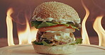 Breakfast burger, flame and rotation with fast food in restaurant for hospitality or take away order. Bacon, cheese and egg with bun turning on table for cooking, eating or gourmet meal in cafe