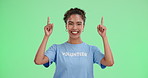 Pointing, volunteer and face of woman by green screen for announcement with ngo business. Happy, portrait and female charity worker with deictic hand gesture for marketing presentation by chroma key.