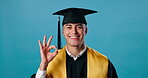 Man, face and ok sign for graduation, success and achievement in school or education in studio. Graduate, happy and award for university, college and certificate as valedictorian on blue background