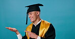 Graduate, face and pointing for mockup space, information and education marketing in studio. Man, happy and presentation for university advertising, news and college announcement on blue background