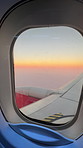 Airplane, window and sky with sunset for travel, journey abroad and wing for moving or vacation. Metal transport, commercial and international flight at dusk for immigration, passenger view and trip