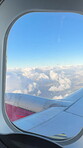 Outdoor, sky and wing of airplane by window, international and flying  for travel journey to London. Transport, abroad and global flight in air for location, destination and movement of aircraft