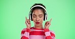 Woman, dancing and green screen or audio headphone, streaming and radio station with energy movement in studio. Happiness, track and music listening on tech with connection, online and good mood
