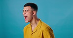 Man, screaming and angry in studio mockup for bad news, tragedy or frustrated. Male person, yell or stress on blue background space for reaction, mental health crisis or burnout in cathartic exercise