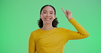 Portrait, woman and pointing up on green screen for news isolated on studio background. Promo, smile and hand gesture for advertising, sales offer and commercial marketing on mockup space coming soon