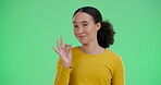 Woman, face and perfect on green screen in studio for positive vote or review, agreement and affirmation. Girl, portrait and hand gesture or like sign for approval, well done and good reputation.