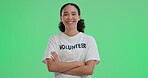 Happy woman, volunteer and confident on green screen for support, NGO work and environment care. Female donor, arms crossed and portrait on chroma key for community service, activism and opportunity