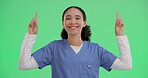 Portrait, woman and nurse pointing up on green screen isolated on studio background. Promo, smile and hand gesture for advertising, medical offer and healthcare insurance on mockup space coming soon