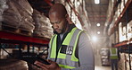 Logistics, black man and tablet in warehouse for order, checklist and inventory management. Male worker, digital technology and factory in shipping company for export, distribution and supply chain