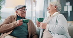 Mature couple, happy and laugh for smile, coffee break and communication in living room. Senior man, woman and relaxing on sofa or couch in house, bonding and together in retirement with warm drink