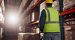 Man, trolley and warehouse with distribution of package for wholesale, delivery and supplier. Logistics, storage and pallet jack with inventory in factory for manufacturing, storehouse and product