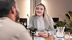 Podcast, interview and woman with mic in conversation for broadcast, recording or guest on talk show. News, info and host with discussion at desk for content creation, live streaming or communication