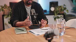 Hands, microphone and radio with host man in recording studio for broadcast or live stream. Creative, interview and media with content creator or influencer speaking on air as talk show presenter