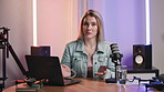 Interview, laptop and microphone with host woman in recording studio for broadcast or live stream. Creative, media and radio podcast with portrait influencer speaking on air as talk show presenter