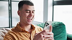 Phone, laughing and man on sofa in home networking on social media, mobile app or internet. Happy, typing and person with comic, funny or comedy joke online with cellphone in living room at house