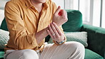 House, closeup and hands of man with wrist pain, injury and mobility problem with muscle strain. Check, broken bone or person with burnout, carpal tunnel and ache with sprain hand and joint in home