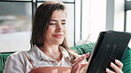 Tablet, reading and woman on sofa in home networking on social media, mobile app or internet. Happy, browse and person with website, blog or online ebook with technology in living room at house