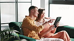 Couple, tablet and smile on sofa in home networking on social media, mobile app or internet. Man, woman and browse with comic, funny joke or online meme with technology in living room at house