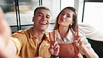 Couple, selfie and smile on sofa in home posting on social media, mobile app or internet. Man, woman and peace sign for bonding, profile picture or relationship with technology in house living room