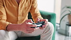 Hands, man and play game with controller for virtual gaming, esports challenge and streaming contest on web. Male person, relax and digital device for arcade competition, online video and house sofa