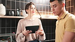 Tablet, cooking and couple in kitchen with recipe online for romantic dinner date at home. Love, digital technology and young man and woman preparing supper meal with tutorial on internet at house.