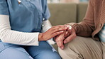 Nurse, man and senior care on sofa with hands, healthcare and support or wellness in apartment together. Woman, living room and trust or professional in retirement home, caregiver and comfort gesture